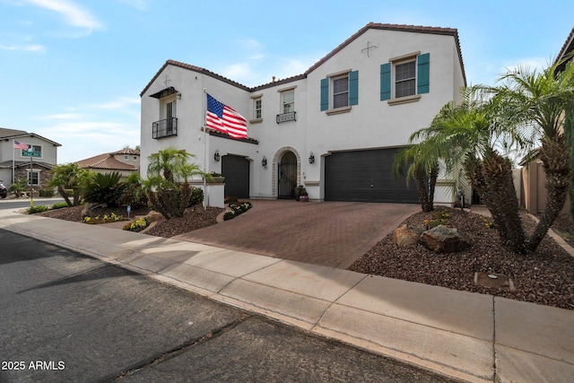 9608 N 184th Ln, Waddell, AZ 85355 - mediterranean / spanish house featuring a garage, decorative driveway, stucco siding, a balcony, and a tile roof