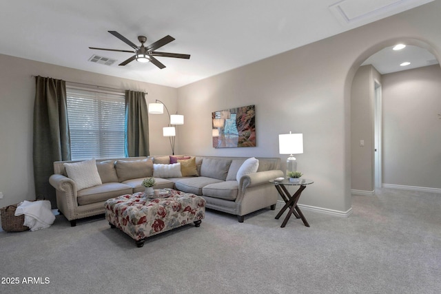 9608 N 184th Ln, Waddell, AZ 85355 - living room featuring carpet, a ceiling fan, arched walkways, and baseboards