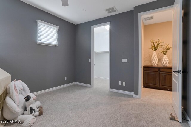 9608 N 184th Ln, Waddell, AZ 85355 - carpeted bedroom with a walk in closet, baseboards, and a ceiling fan