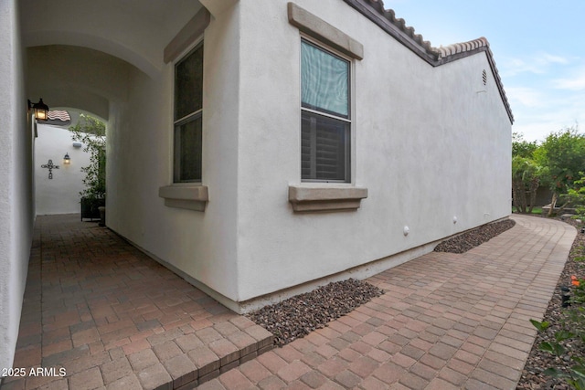 9608 N 184th Ln, Waddell, AZ 85355 - view of property exterior featuring stucco siding and a patio area