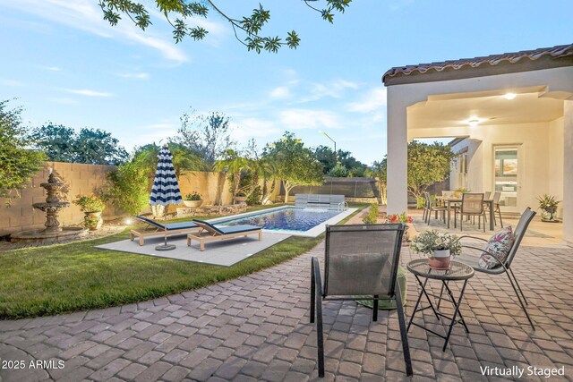 9608 N 184th Ln, Waddell, AZ 85355 - fenced backyard featuring a patio and outdoor dining area