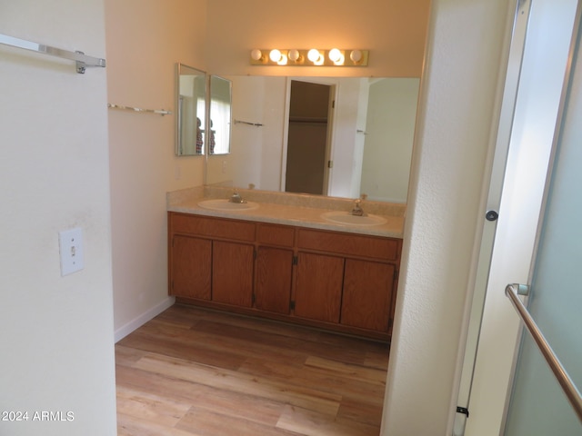 bathroom featuring vanity, a shower with door, and hardwood / wood-style floors