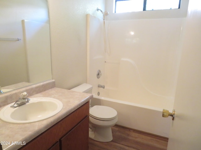 full bathroom featuring tub / shower combination, vanity, toilet, and wood-type flooring