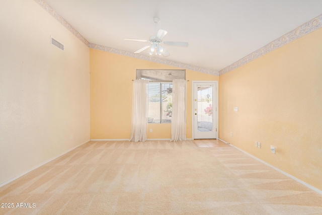 carpeted spare room featuring ceiling fan and lofted ceiling