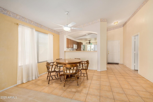 tiled dining room with ceiling fan and a wealth of natural light