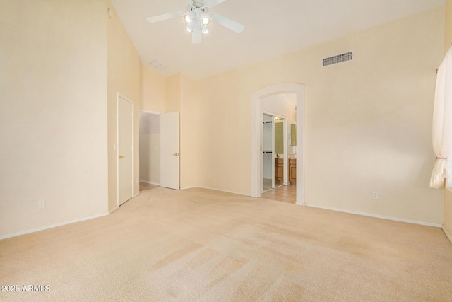 carpeted spare room featuring ceiling fan