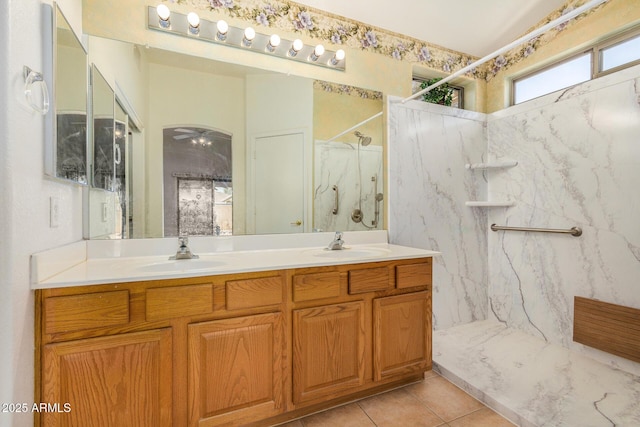 bathroom with tile patterned flooring, vanity, ceiling fan, and walk in shower