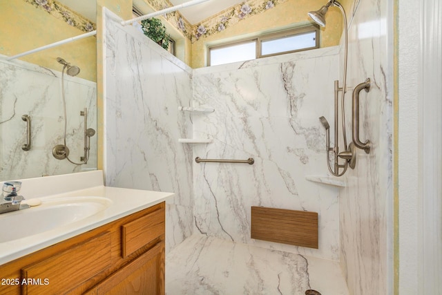 bathroom featuring a tile shower and vanity