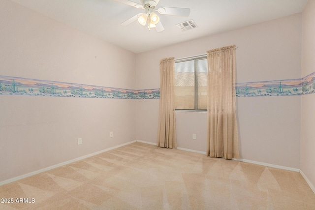 spare room featuring ceiling fan and light colored carpet