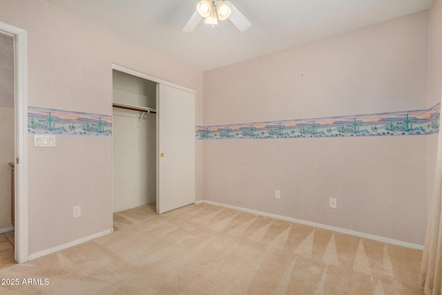 unfurnished bedroom featuring ceiling fan, light carpet, and a closet