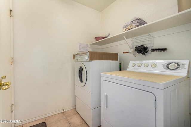 washroom with washing machine and dryer and light tile patterned floors