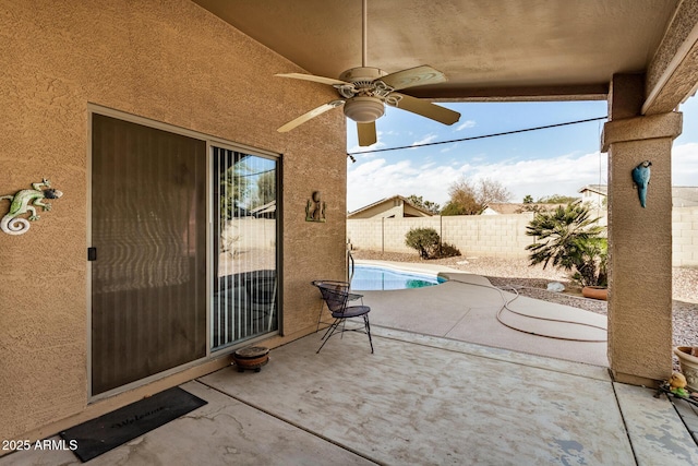 view of patio with a fenced in pool and ceiling fan