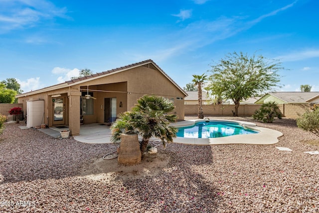 view of swimming pool with ceiling fan and a patio