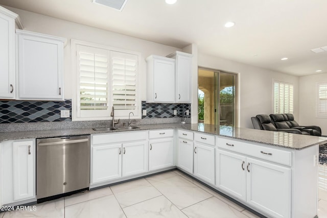 kitchen with dishwasher, kitchen peninsula, white cabinetry, and sink