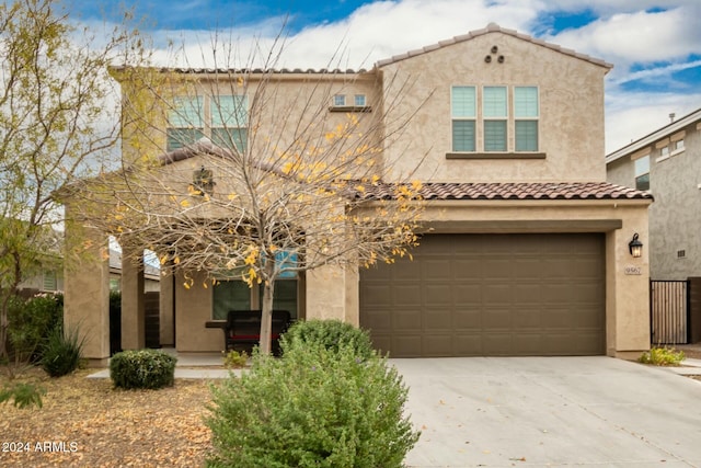 mediterranean / spanish-style home with a garage