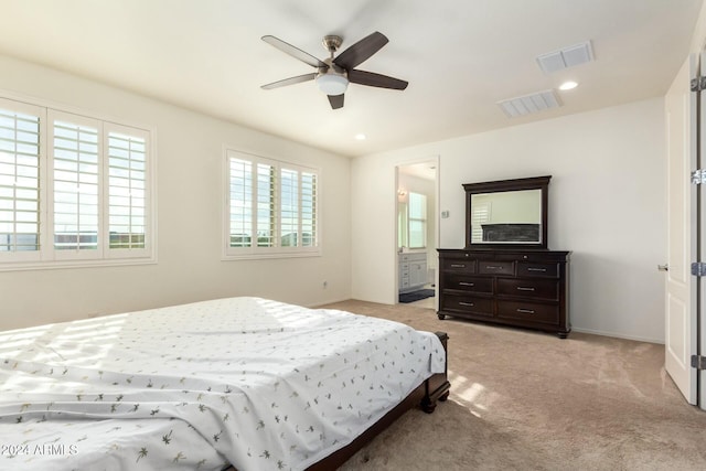 carpeted bedroom with ceiling fan and ensuite bathroom