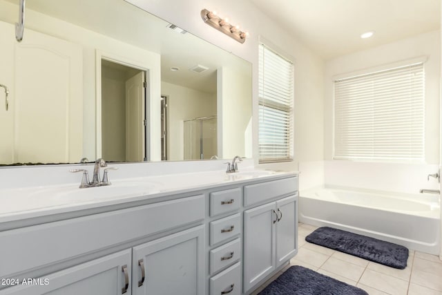 bathroom featuring tile patterned floors, vanity, and plus walk in shower