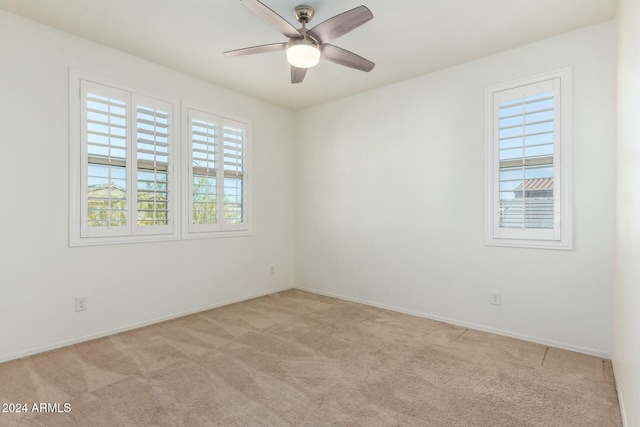 empty room featuring light carpet and ceiling fan