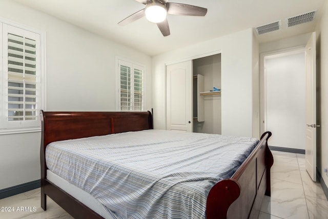 bedroom with ceiling fan and a closet