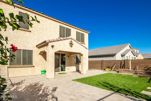 rear view of house featuring a patio