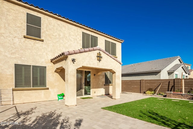 rear view of property featuring a patio