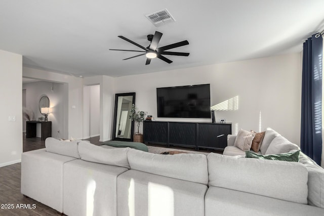 living room with ceiling fan and dark hardwood / wood-style flooring