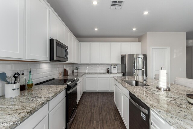 kitchen featuring white cabinetry, stainless steel appliances, tasteful backsplash, sink, and dark hardwood / wood-style floors