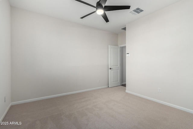 empty room with ceiling fan and light carpet