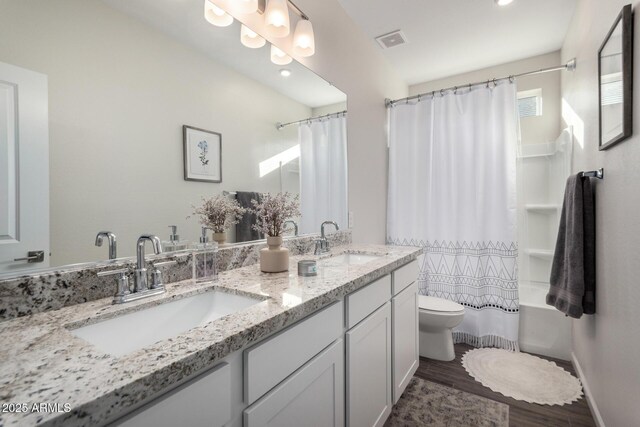 full bathroom with wood-type flooring, toilet, vanity, and shower / tub combo with curtain