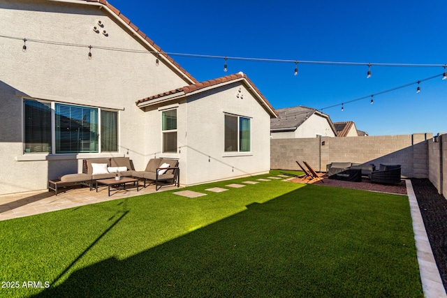 back of property featuring a patio area, outdoor lounge area, and a lawn