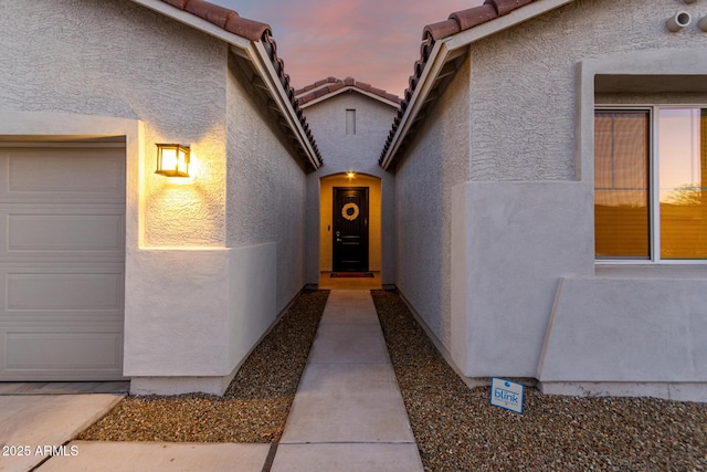 view of exterior entry at dusk