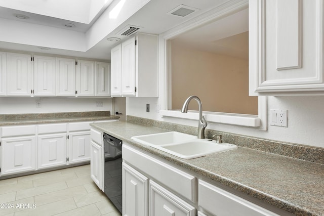 kitchen featuring white cabinets, light tile patterned floors, black dishwasher, and sink