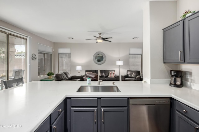 kitchen featuring dishwasher, sink, gray cabinetry, and ceiling fan