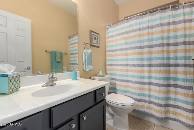 bathroom with vanity, toilet, and tile patterned flooring