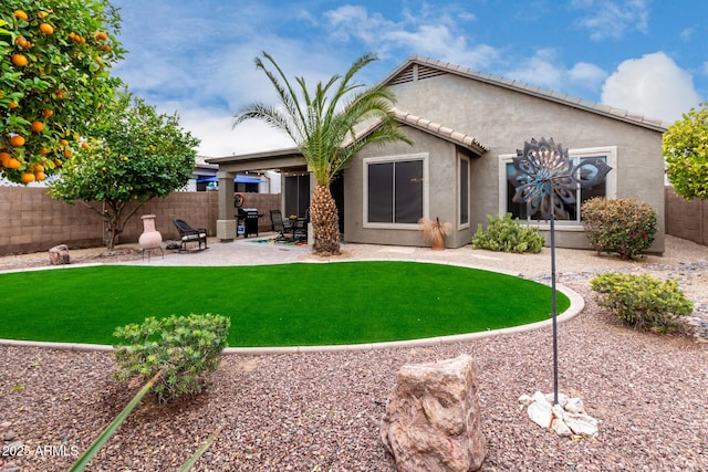 back of property featuring a yard and a patio area