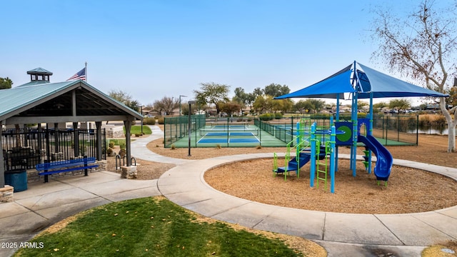 view of play area featuring a water view and tennis court