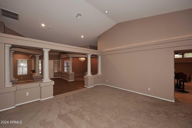 unfurnished living room with lofted ceiling and dark colored carpet