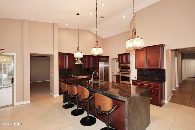 kitchen featuring tasteful backsplash, stainless steel fridge, sink, and light tile patterned floors