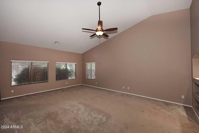 carpeted spare room featuring ceiling fan and lofted ceiling