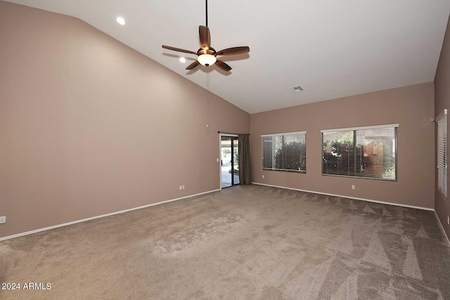 empty room featuring carpet floors, high vaulted ceiling, and ceiling fan