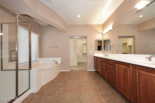 bathroom featuring vanity and independent shower and bath