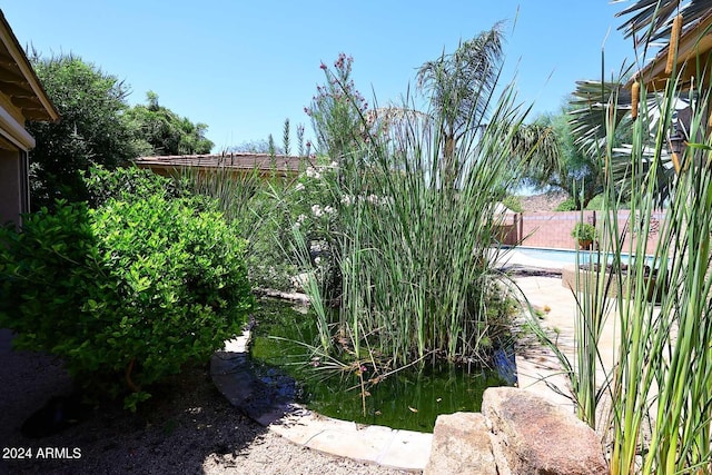 view of yard with a fenced in pool