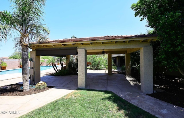 view of vehicle parking with a gazebo and ceiling fan