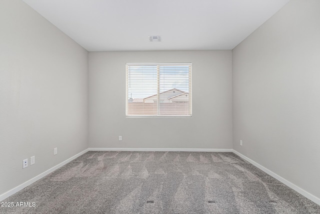 carpeted empty room featuring baseboards and visible vents