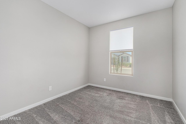 empty room featuring baseboards and carpet floors