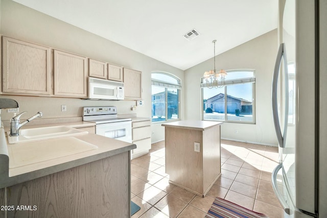 kitchen featuring vaulted ceiling, a kitchen island, white appliances, hanging light fixtures, and light brown cabinetry