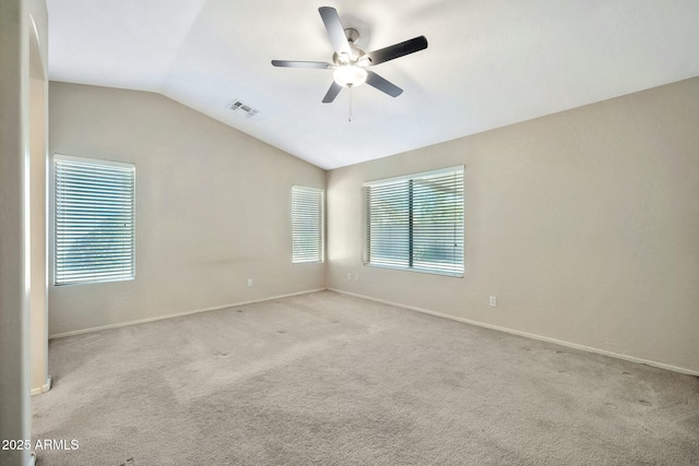 unfurnished room with ceiling fan, light colored carpet, and vaulted ceiling