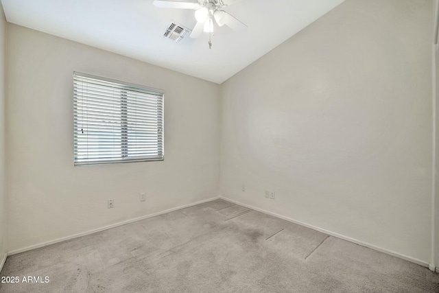 carpeted spare room with ceiling fan