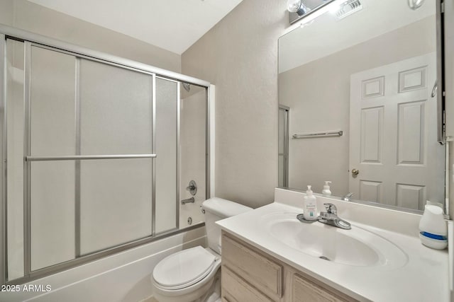 full bathroom with toilet, bath / shower combo with glass door, and vanity