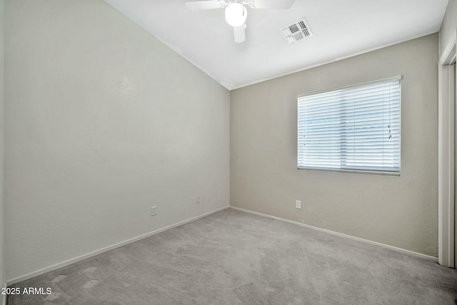 carpeted spare room featuring ceiling fan and lofted ceiling